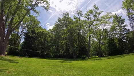 Time-lapse-of-backyard-in-daytime-of-moving-clouds-blocking-the-sun