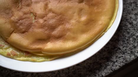 Close-Up-Of-Homemade-Crepes,-Thin-Pancakes-On-White-Ceramic-Plate