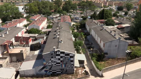 Neighborhood-Padre-Cruz,-located-at-the-northern-end-of-the-municipality-of-Lisbon,-the-small-houses-with-lusalite-and-zinc-roofing,-image-seen-from-above