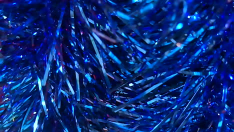 Christmas-decorative-embellishment,-hanging-tinsel-material-of-shining-blue-in-slow-motion