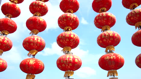 Chinese-lanterns-hanging-high-in-the-blue-sky,-become-a-series-lines-of-lanterns-scenes-or-backdrop-in-Sai-Kung,-Hong-Kong