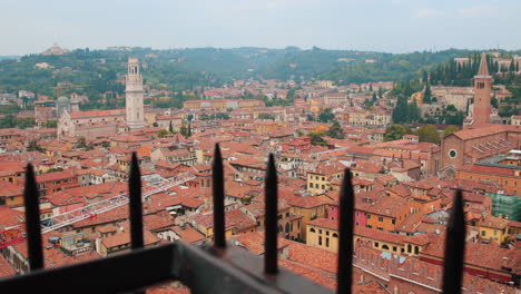 Slow-motion-clip-of-the-city-landscape-of-Verona,-with-an-alone-man-watching-the-city-from-above