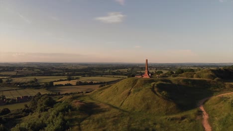 Drone-Pan-of-War-Memorial-on-a-Hill-in-the-Countryside-at-Sunset