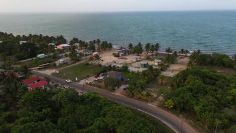 Van-Driving-On-Road-In-Caribbean-Beach-Village-Aerial-Shot-4K