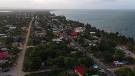 School-Bus-on-Caribbean-Beach-Village-Road-Aerial-Shot-4K