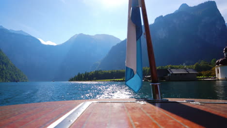 Waving-Bavarian-Flag-from-the-ferry-on-sunny-Königssee-in-Bavaria,-Germany