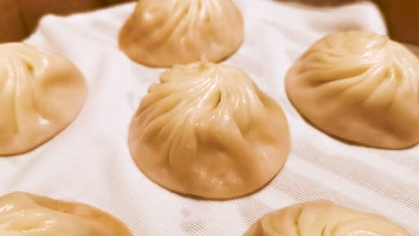 Chinese-style-restaurant,-famous-Shanghai-cuisine,-fresh-hot-Xiao-Long-Bao-in-streamer