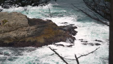 static-clip-of-tide-crashing-against-rocks-in-the-ocean