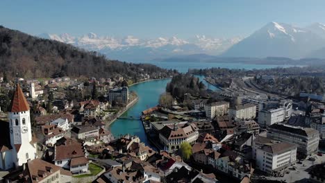 Aerial-view-of-an-old-authentic-city-of-Switzerland-with-beautiful-alps-and-lake-background