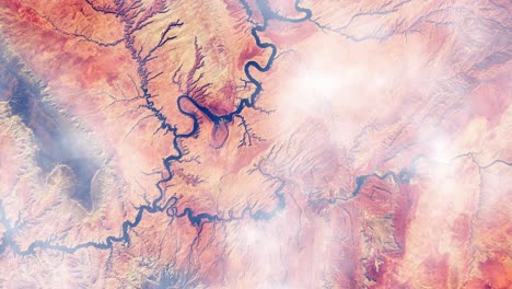 High-altitude-drone-aerial-flight-over-clouds-with-top-down-view-of-red-and-sandy-desert-area-with-riverbeds