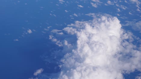 Nube-De-Algodón-Blanco-Esponjoso-Y-Grueso-En-El-Cielo-Azul,-Alta-Vista-Volando-Desde-El-Avión