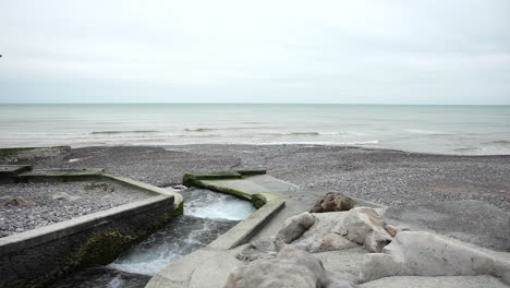Smallest-french-river-flows-into-the-sea-on-a-cloudy-day-in-Normandy