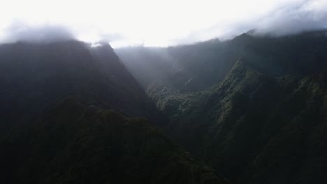 Madeira,-Portugal---Beam-Of-Sunlight-Shining-Down-On-The-Lush-Mountain-Range---Aerial-Drone-Shot