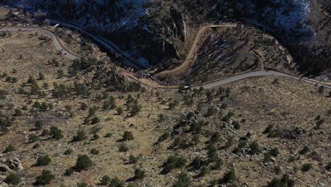 Mountain-Ridge-Highway-Cars-Pan-Down-Aerial-Reveal-Shot-4K