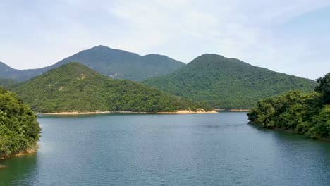 Beautiful-Tai-Tam-Reservoir-at-Hong-Kong,-green-environment-mountain-landscape,-Panning-shot