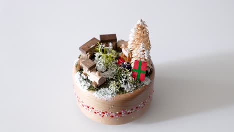 Handmade-wooden-Christmas-music-box,-scene-of-train,-trees-and-gifts-view,-studio-white-background