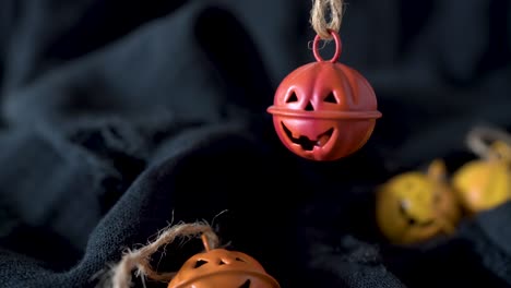 Metal-halloween-pumpkins-head-bells-waving-in-the-dark,-create-dramatic-promotion-background,-space-for-message