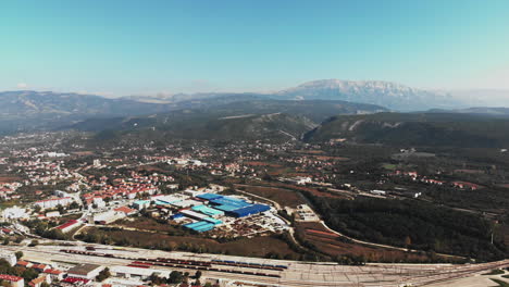 Drone-flying-above-a-small-Croatian-city-with-much-industry-and-a-big-railway-station