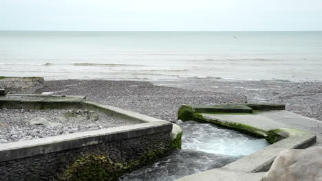 Smallest-french-river-flows-into-the-sea-on-a-cloudy-day-in-Normandy