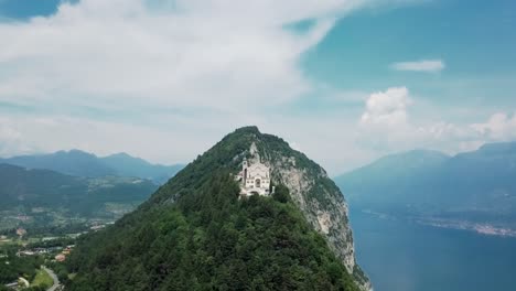 Drone-shot-of-Santuario-Di-Montecastello-on-cliff-next-to-Lake-Garda
