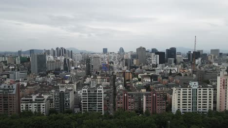 Aerial-shot-flying-over-densely-populated-built-up-city-area,-Seoul-South-Korea