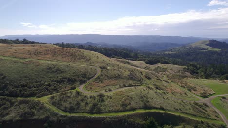 Drone-jibing-down-across-rolling-Northern-California-hills-during-golden-hour