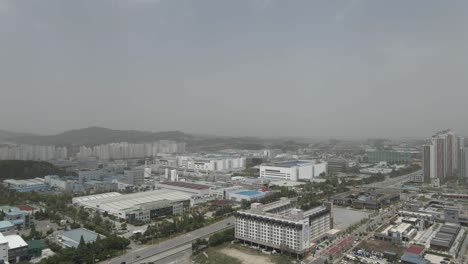 Aerial-drone-shot-flying-over-Cheonan-city-covered-in-smog-pollution,-South-Korea
