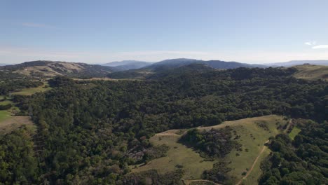 Aerial-drone-panning-right-across-rolling-Northern-California-hills-during-golden-hour