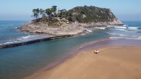 Drone-aerial-view-of-the-San-Nicolás-island-at-the-beach-of-Lekeitio-in-the-Basque-Country