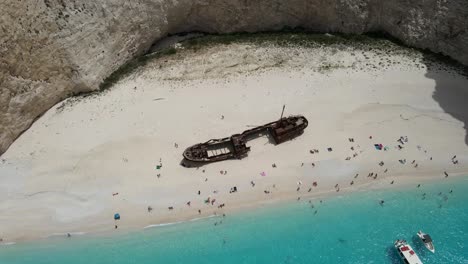 Aerial-view-of-navagio-crystal-water-shipwreck-beach-in-Zakynthos,-Greece,-during-summer