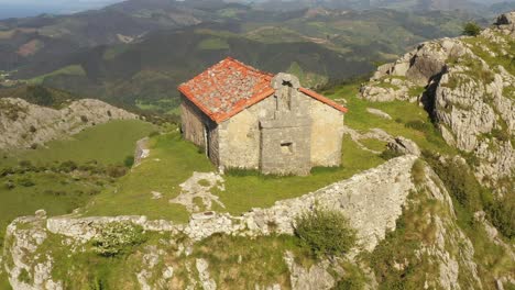 Aerial-drone-view-of-the-hermitage-of-Santa-Eufemia-on-the-top-of-a-mountain-in-Aulestia-in-the-Basque-Country