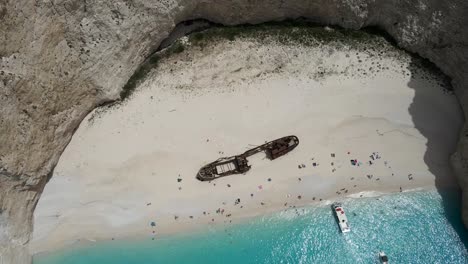 Aerial-view-of-Panagiotis,-a-Greek-shipwreck-boat-lying-in-the-white-sands-of-an-exposed-cove-on-the-coast-of-Zakynthos,-Ionian-Island