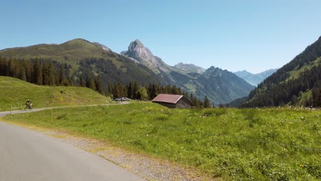 Clip-of-a-man-biking-in-the-pragelpass,-sport-in-the-mountains,-sunny-day
