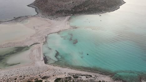 Aerial-footage-of-paradisiac-Balos-beach-and-lagoon-near-Gramvousa-island-with-azure-clear-water-in-Crete,-Greece