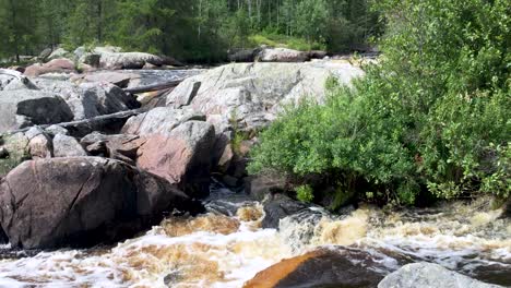 Canadian-Boreal-shield-Etomami-river-flowing-over-Onakamees-rapids-pan-left-near-Berens-River-Northern-Manitoba-Canada