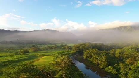 Jungle-Valley-Sunrise-Aerial-Shot-Through-Fog-Mountain-Reveal