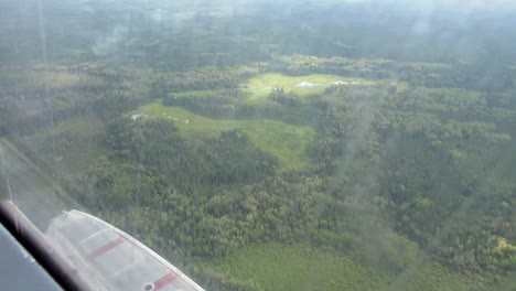 Seaplane-cockpit-passenger-POV-flying-over-swampy-forest-Northern-Manitoba-Canada