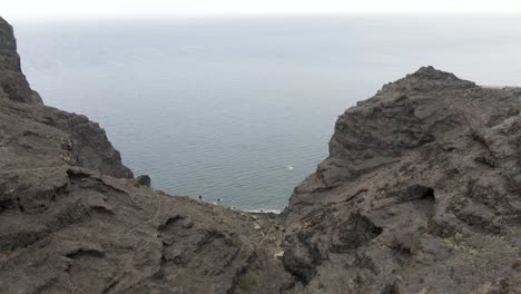 Drone-aerial-view-of-the-sea-horizon-in-a-rocky-cliff-in-La-Palma,-Canary-Islands,-on-a-foggy-day