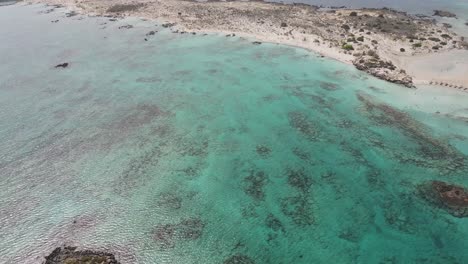 Top-view-from-drone-of-amazing-peninsula-and-sandy-beach-on-Crete,-Greece