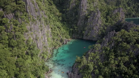 Limestone-Cliffs-Towering-Around-Crystal-clear-Blue-Lagoon-In-El-Nido-Island-In-Palawan,-Philippines