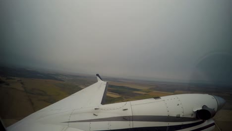 Small-propeller-airplane-takeoff-time-lapse-wing-engine-POV-on-rainy-day-over-farmers-fields-Winnipeg-Manitoba-Canada