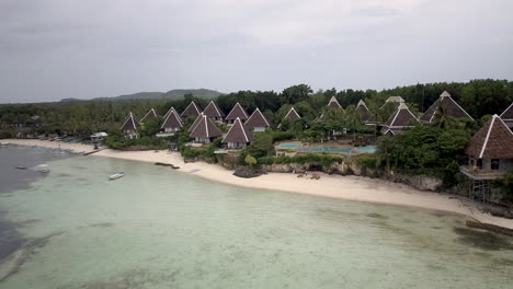 Scenic-View-Of-Beach-Resort-With-Uniquely-Shaped-Cottages---aerial-shot