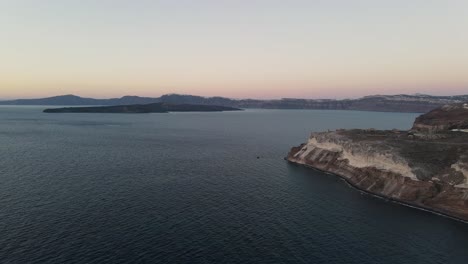 Flying-over-the-volcanic-caldera-of-Santorini-during-sunset