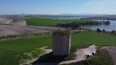 Aerial-drone-orbiting-historic-ruin-tower-in-beautiful-nature-landscape-scenery,-Spain