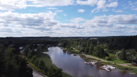 Aerial-panning-shot-of-idyllic-forest-landscape-and-Porvoonjoki-River-in-Porvoo-during-sunny-day