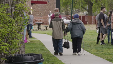 People-walk-along-a-promenade-during-Dogwood-Festival,-Siloam-Springs,-Arkansas