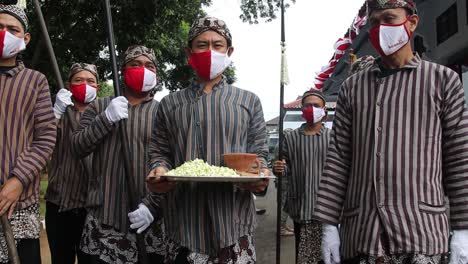Javanese-man-burning-incense-before-the-traditional-procession,-Batang,-Indonesia,-April-5,-2021