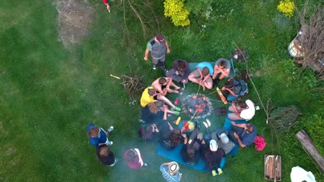 Young-Teenage-Friends-Doing-Campfire-Bbq,-Hiking-Trip,-Togetherness,-Aerial-Rising