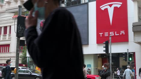 People-are-seen-walking-past-the-American-electric-company-car-Tesla-Motors-official-authorized-car-dealer-store-seen-in-Hong-Kong