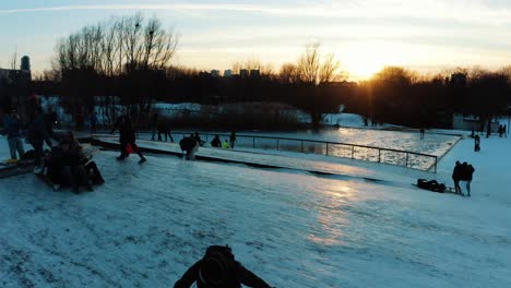 Aerial-shot-of-a-group-of-people-ice-skating-and-having-fun-during-the-sunset-in-Utrecht